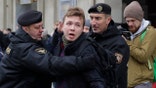 FILE - In this Sunday, March 26, 2017 file photo, Belarus police detain journalist Raman Pratasevich, center, in Minsk, Belarus. Raman Pratasevich, a founder of a messaging app channel that has been a key information conduit for opponents of Belarus’ authoritarian president, has been arrested after an airliner in which he was riding was diverted to Belarus because of a bomb threat. The presidential press service said President Alexander Lukashenko personally ordered that a MiG-29 fighter jet accompany the Ryanair plane — traveling from Athens, Greece, to Vilnius, Lithuania — to the Minsk airport. ﻿﻿(AP Photo/Sergei Grits, File)