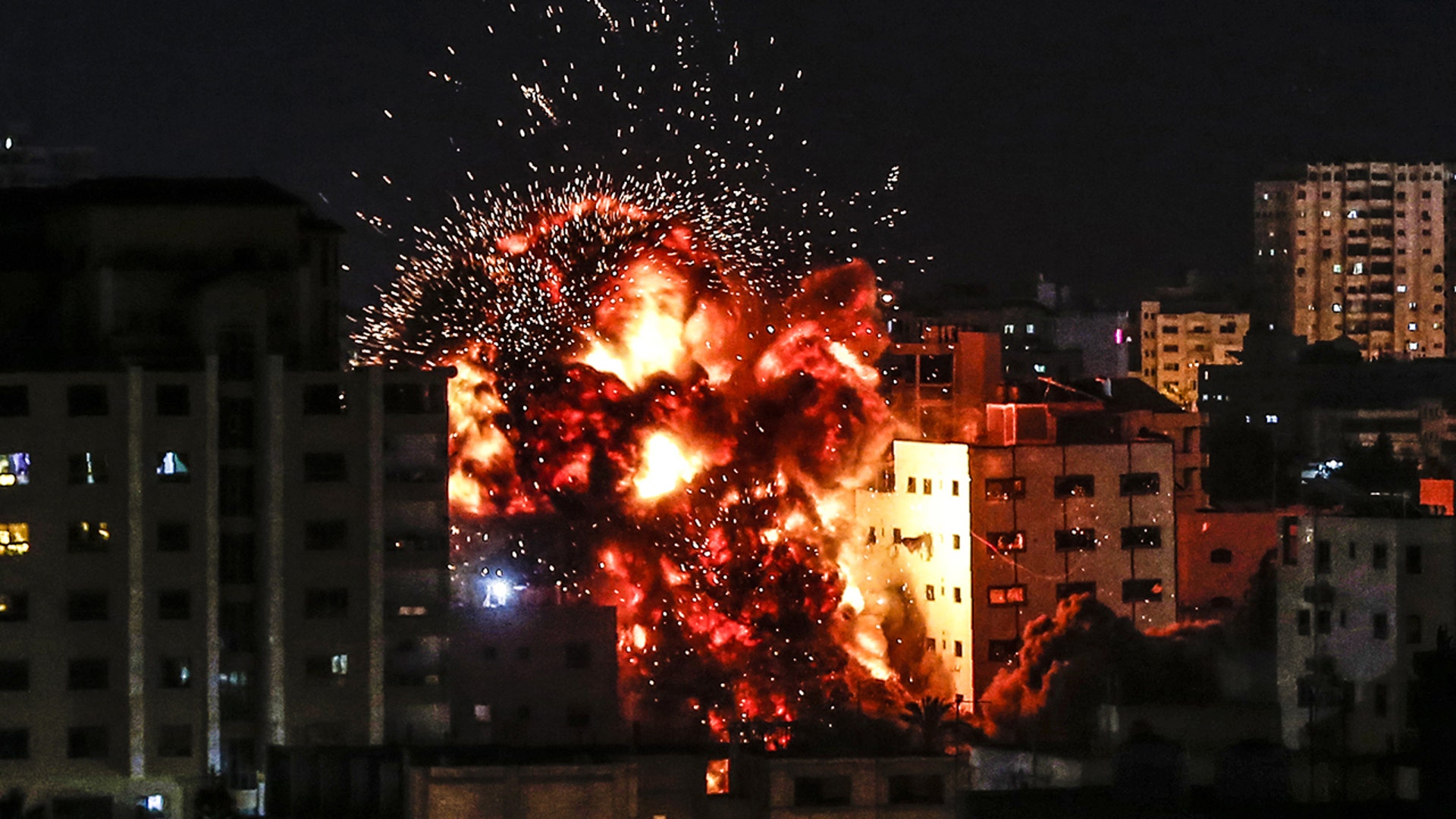 An explosion among buildings during an Israeli airstike on Gaza City on May 4, 2021. Gaza militants fired a barrage of rockets at Israel, which responded with airstrikes, officials said, as a fragile ceasefire again faltered. (MAHMUD HAMS/AFP via Getty Images)