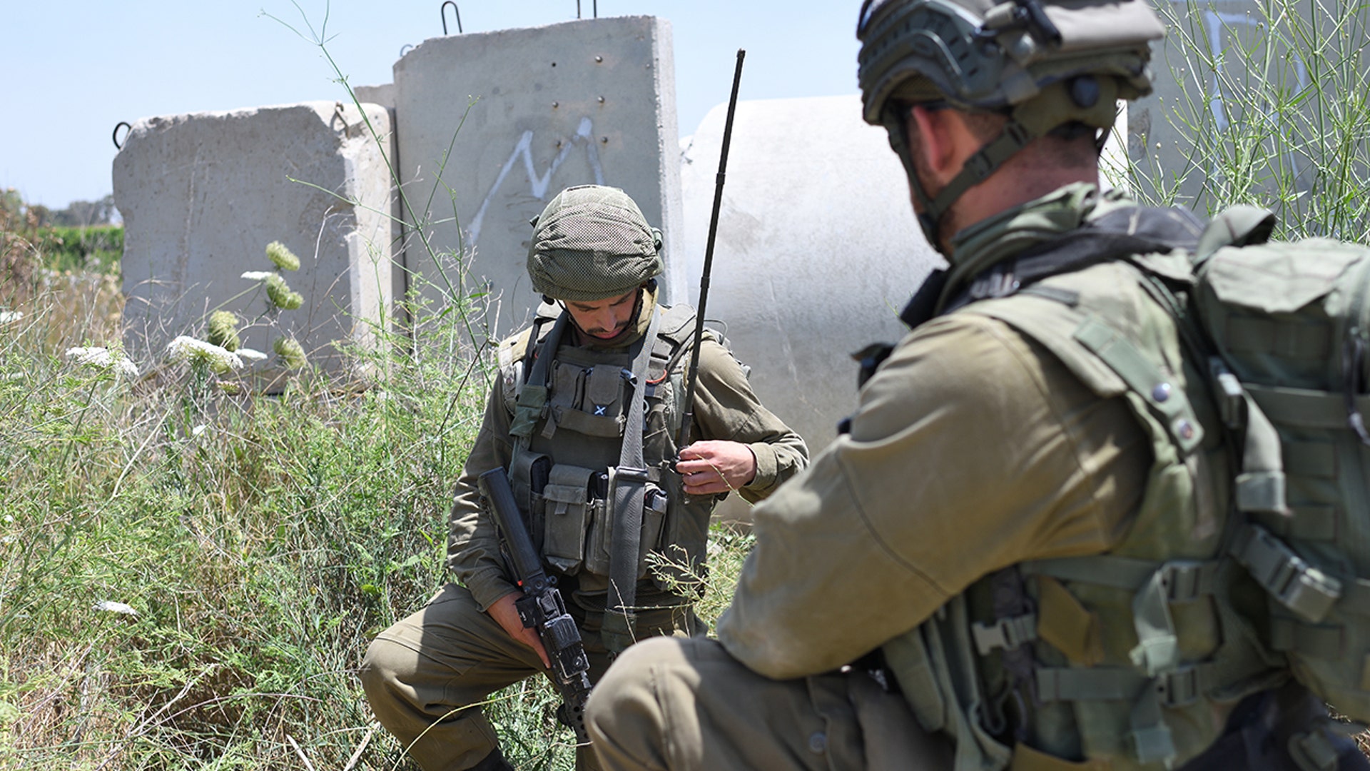Israeli soldiers hold positions at Netiv Ha'Asara near the site where an IDF vehicle was directly hit by a rocket fired from Gaza strip, injuring two and killing one, in Netiv Ha'Asara. May 12, 2021. (Gili Yaari/NurPhoto via Getty Images)