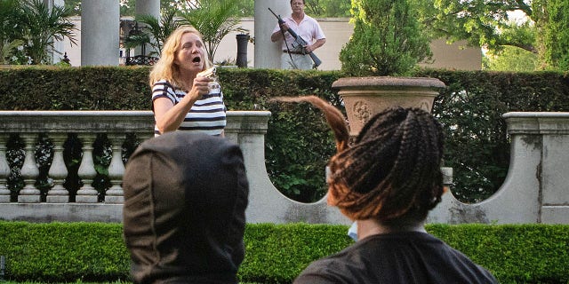 Patricia McCloskey and her husband Mark McCloskey draw their firearms on protesters as they enter their neighborhood during a protest against St. Louis Mayor Lyda Krewson, in St. Louis, Missouri on June 28, 2020.