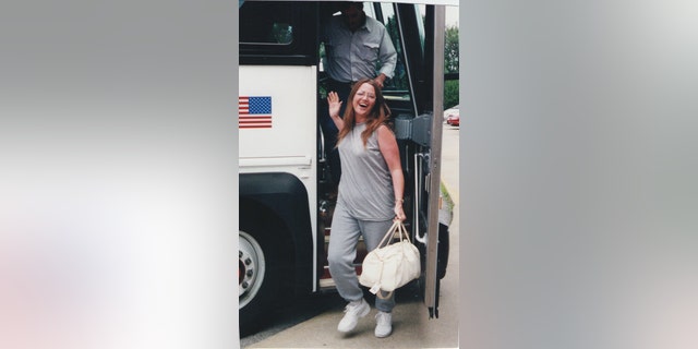 Lori Arnold steps off the bus as she returns home to Ottumwa, IA, from her first prison sentence in 1999.