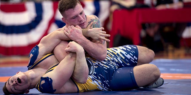 Marine Sgt. John Stefanowicz, from Kennerdell Pa., pins Navy Petty Officer Joseph Marques from Punta Gorda, Fla., during the 82 kg weight class of the 2018 Armed Forces Wrestling Championship Greco-Roman competition. (U.S. Navy photo by Mass Communication Specialist 1st Class Gulianna Dunn/Released)