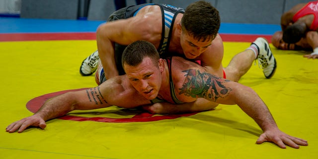 U.S. Marine Corps Capt. Peyton Walsh, top, and Staff Sgt. John Stefanowicz, bottom, with the All-Marine Wrestling Team (AMWT), hone their wrestling techniques to prepare for the Olympic Trials, on Marine Corps Air Station New River, North Carolina, Jan. 8, 2021.