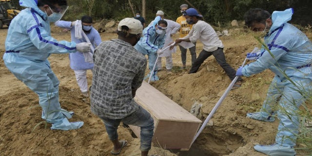 <strong>Relatives bury the body of a COVID-19 victim at a graveyard in New Delhi, India, Tuesday, May 4, 2021. (AP Photo/Ishant Chauhan)</strong>