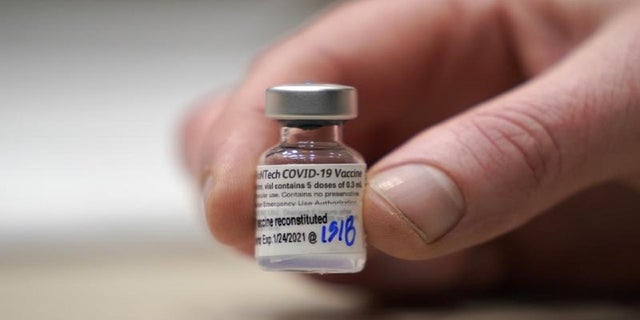 This Jan. 24, 2021, file photo shows a vial of the Pfizer vaccine for COVID-19 in Seattle, Wash. 
