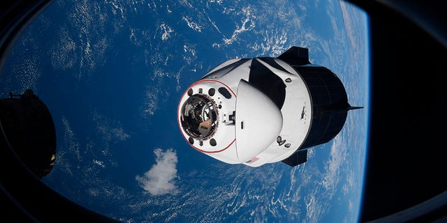 In this Saturday, April 24, 2021, photo made available by NASA, the SpaceX Crew Dragon capsule approaches the International Space Station for docking. 