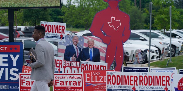 Sign supporting various candidates sit outside an early voting location Tuesday, April 27, 2021, in Mansfield, Texas. (AP Photo/LM Otero)