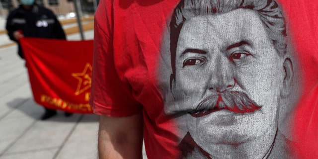 A man wearing a shirt with the image of former Soviet dictator Joseph Stalin attends May Day in Belgrade, Serbia. (AP Photo/Darko Vojinovic)
