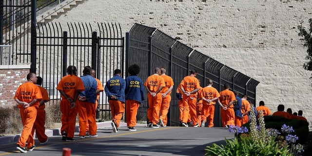 Inmates march in line at San Quentin State Prison in San Quentin, California, August 16, 2016.