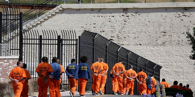 Inmates walk in a line at San Quentin State Prison in San Quentin, California, Aug. 16, 2016.