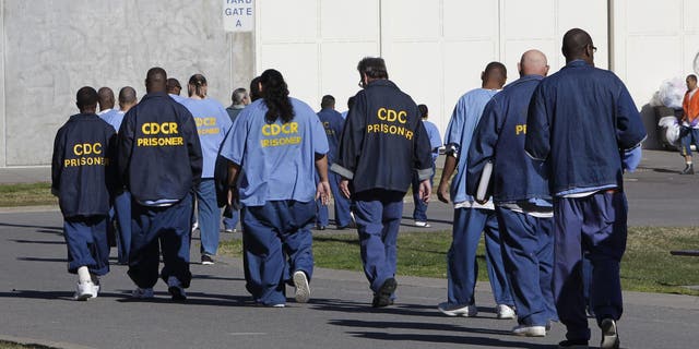 FILE - In this archive image from February 26, 2013, inmates walk through the training camp at California State Prison Sacramento, near Folsom, California (AP Photo / Rich Pedroncelli, File)