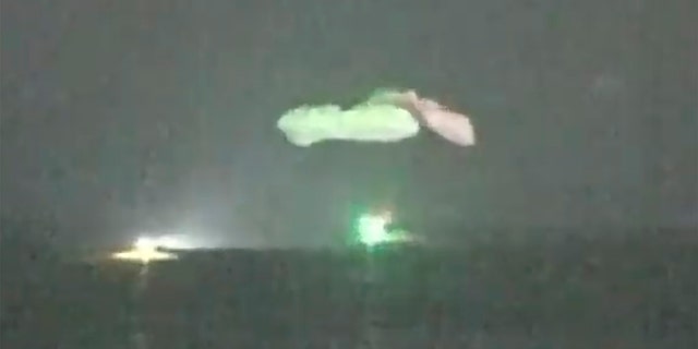 In this image taken from a NASA television video, the SpaceX Dragon capsule lands in the Gulf of Mexico near the Florida Panhandle early Sunday, May 2, 2021. SpaceX fired four astronauts from the International Space Station on Sunday, making the first landing of the American crew in the dark from the Apollo 8 moonshot. (NASA TV via AP)