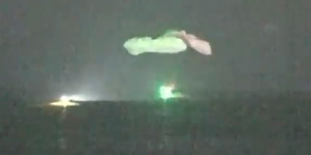 In this image made from NASA TV video, the SpaceX Dragon capsule lands into the Gulf of Mexico near the Florida Panhandle early Sunday, May 2, 2021. SpaceX returned four astronauts from the International Space Station on Sunday, making the first U.S. crew splashdown in darkness since the Apollo 8 moonshot. (NASA TV via AP)