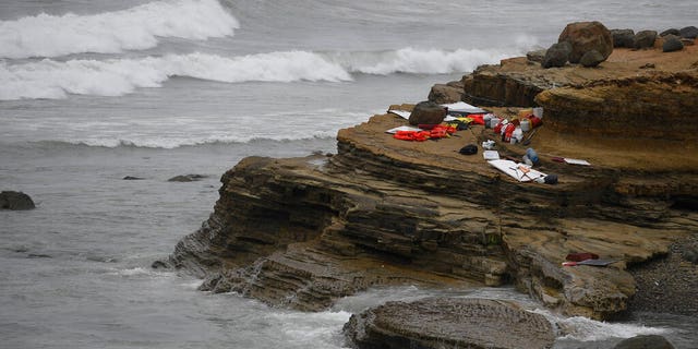 Items from a boat sit on the shoreline at Cabrillo National Monument near where it capsized just off the San Diego coast Sunday, May 2, 2021, in San Diego.