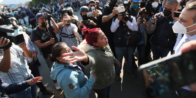 A woman demands information from a lawmaker of people injured when a metro overpass collapsed, near the site of the wreckage in Mexico City, Tuesday, May 4, 2021. (AP Photo/Fernando Llano)