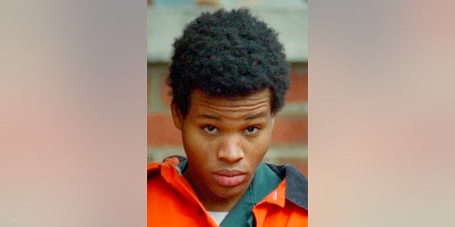 Lee Boyd Malvo is escorted out of Fairfax Juvenile and Domestic Relations Court after a hearing in Fairfax, Virginia on Dec. 30, 2002. 