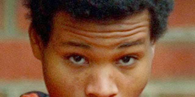 Lee Boyd Malvo is escorted out of Fairfax Juvenile and Domestic Relations Court after a hearing in Fairfax, Virginia on Dec. 30, 2002. 