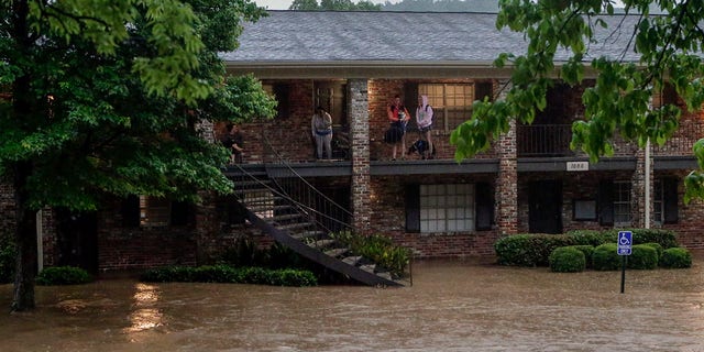 Residents of the Crescent at Lakeshore apartment complex wait to be rescued by Homewood Fire and Rescue as severe weather produced torrential rainfall flooding several apartment buildings Tuesday, May 4, 2021 in Homewood, Ala. (AP Photo/Butch Dill)