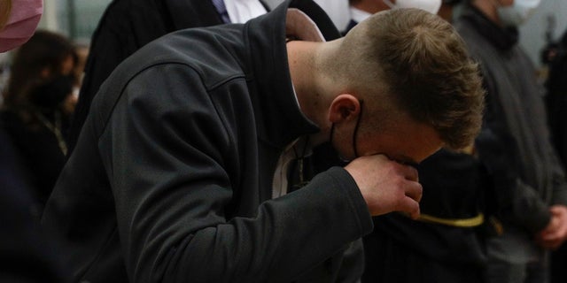 Finnegan Lee Elder wipes a tear Wednesday as he listens as the verdict is read, in the trial for the slaying of an Italian plainclothes police officer in summer 2019, in Rome. A jury in Rome convicted two American friends in the 2019 slaying of a police officer in a drug sting gone awry, sentencing them to life in prison. The jury deliberated more than 12 hours before delivering the verdicts against Finnegan Lee Elder, 21, and Gabriel Natale Hjorth, 20, handing them Italy's stiffest sentence. (AP Photo/Gregorio Borgia)