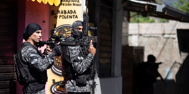 Police conduct an operation against alleged drug traffickers in the Jacarezinho favela of Rio de Janeiro, Brazil, Thursday, May 6, 2021. (AP Photo/Silvia Izquierdo)