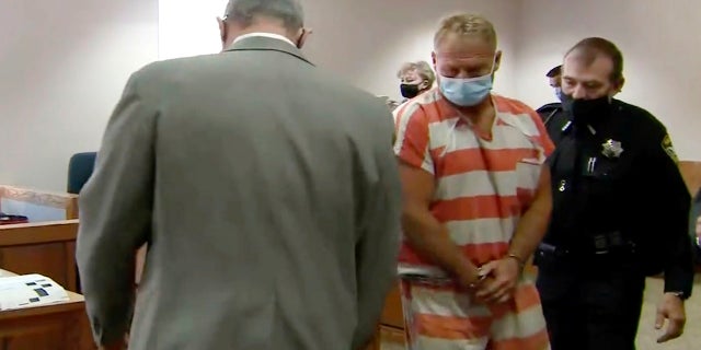 In this still image from video, Barry Morphew, center, appears in court in Salida, Colo., Thursday, May 6, 2021. Morphew was arrested on Wednesday, May 5, in connection with the disappearance of his wife, Suzanne Morphew, who was last seen a year ago on Mother's Day, May 10, 2020. (KUSA via AP, Pool)