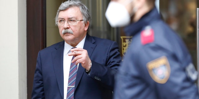 Russia's governor to the International Atomic Energy Agency (IAEA), Mikhail Ulyanov, has a cigarette break outside of the Grand Hotel Wien, where closed-door nuclear talks with Iran take place in Vienna, Austria, Friday, May 7, 2021. (AP Photo/Lisa Leutner)