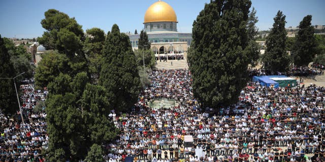 Worshippers take part in the last Friday prayers of the Muslim holy month of Ramadan at the Dome of the Rock Mosque in the Al Aqsa Mosque compound in the Old City of Jerusalem Friday.