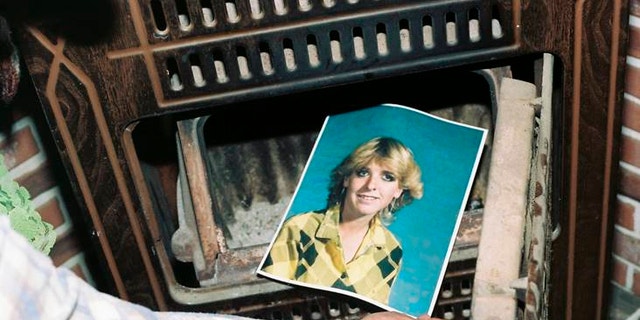 his undated photo provided by the Yavapai County Sheriff's Office shows a law enforcement official discovering a photograph of Pamela Pitts in the wood stove of a home she shared with two others in Prescott, Ariz., in 1988. Pitts' then-roommate, Shelly Harmon, recently confessed to killing Pitts and was sentenced to time she already had served in another killing. (Yavapai County Sheriff's Office via AP)