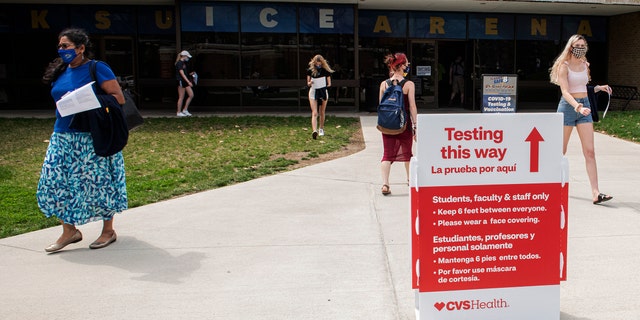 FILE - In this April 8, 2021, file photo, students exit the KSU Ice Arena after getting their Johnson & Johnson COVID-19 vaccination at Kent State University in Kent, Ohio. Even as restrictions relax across much of the United States, colleges and universities have taken new steps to police campus life as the virus spreads through students who are among the last adults to get access to vaccines. (AP Photo/Phil Long, File)