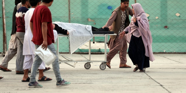 An injured school student is transported to a hospital after a bomb explosion near a school west of Kabul, Afghanistan, Saturday, May 8, 2021. A bomb exploded near a school in west Kabul on Saturday, killing several, many them young students, Afghan government spokesmen said. (AP Photo/Rahmat Gul)