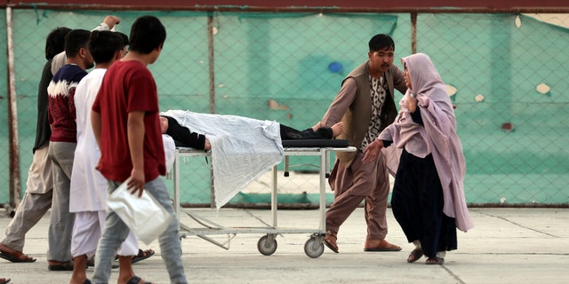 An injured school student is transported to a hospital after a bomb explosion near a school west of Kabul, Afghanistan, Saturday, May 8, 2021. A bomb exploded near a school in west Kabul on Saturday, killing several, many them young students, Afghan government spokesmen said. (AP Photo/Rahmat Gul)