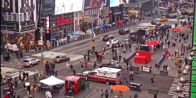 In this image taken from video by the FDNY, pedestrians hurry away from the scene of a shooting in Times Square, Saturday, May 8, 2021, in New York. New York City police say three innocent bystanders including a 4-year-old girl who was toy shopping have been shot in Times Square and officers are looking for suspects. All the victims are expected to recover. (FDNY via AP)