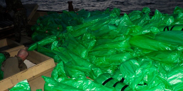 Plastic-wrapped weapons are seen on the deck of a stateless dhow that the U.S. Navy said carried a hidden arms shipment in the Arabian Sea on Friday, May 7, 2021. The U.S. Navy announced Sunday it seized the arms shipment hidden aboard the vessel in the Arabian Sea, the latest-such interdiction by sailors amid the long-running war in Yemen. (U.S. Navy via AP)
