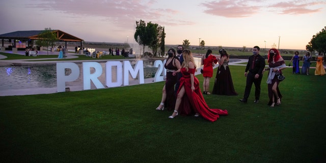 Young people attend prom at the Grace Gardens Event Center in El Paso, Texas on Friday, May 7, 2021. Around 2,000 attended the outdoor event at the private venue after local school districts announced they would not host proms this year. Tickets cost $45. (AP Photo/Paul Ratje)