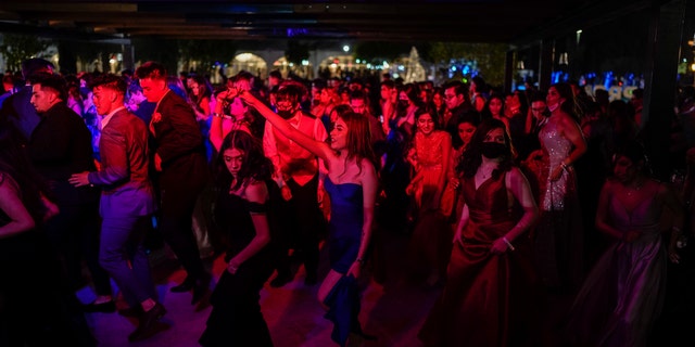 Young people attend prom at the Grace Gardens Event Center in El Paso, Texas on Friday, May 7, 2021. Around 2,000 attended the outdoor event at the private venue after local school districts announced they would not host proms this year. Tickets cost $45. (AP Photo/Paul Ratje)