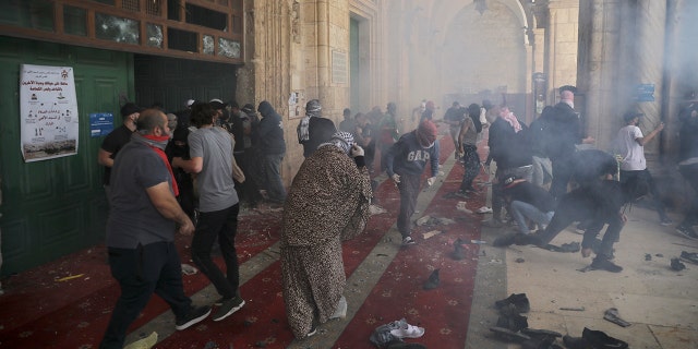 Palestinians clash with Israeli security forces at the Al Aqsa Mosque compound in Jerusalem's Old City Monday, May 10, 2021. (AP Photo/Mahmoud Illean)