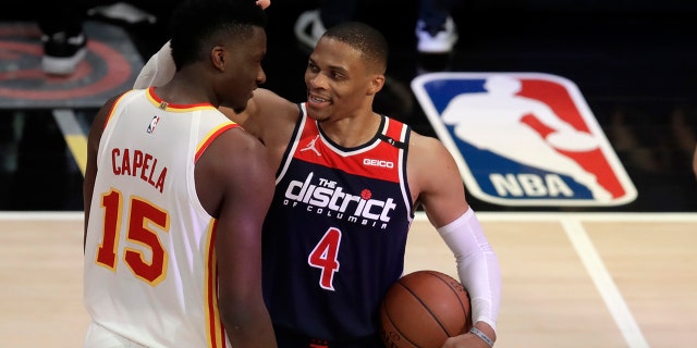 Washington Wizards' Russell Westbrook (4) is congratulated by Atlanta Hawks' Clint Capela at the end of an NBA basketball game Monday, May 10, 2021, in Atlanta. (AP Photo/Ben Margot)