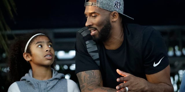 Former Los Angeles Laker Kobe Bryant and his daughter Gianna at a sports event. They both died in a 2020 helicopter crash.