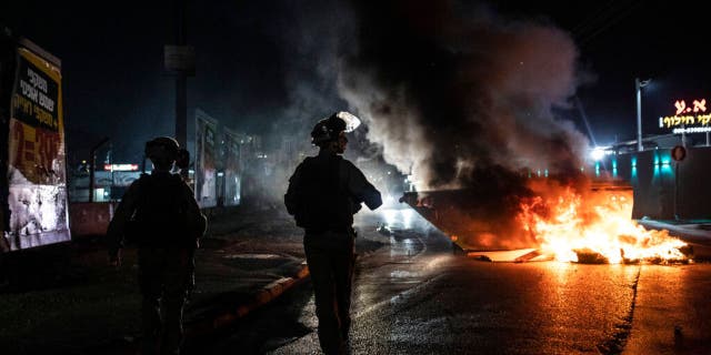Israeli police patrol during clashes between Arabs, police and Jews, in the mixed town of Lod, central Israel, Wednesday, May 12, 2021.