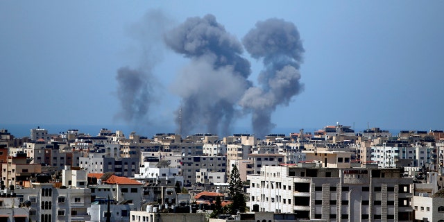 Smoke rises following Israeli airstrikes on a building in Gaza City on Thursday, May 13, 2021. Israeli airstrikes on Wednesday killed several senior Hamas military officials and toppled two towers housing Hamas facilities. (AP Photo / Hatem Moussa)