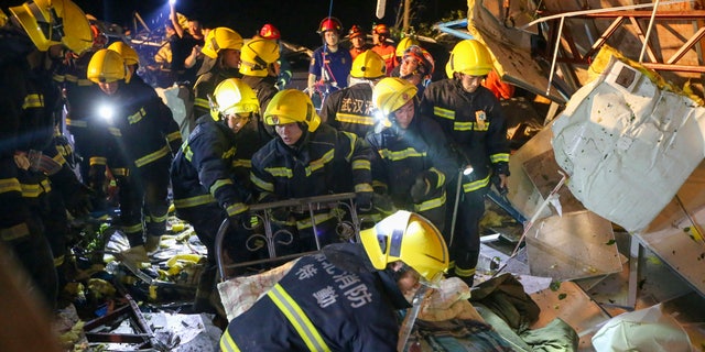 In this photo released by China's Xinhua News Agency, emergency personnel search through the wreckage of buildings destroyed by a reported tornado in Wuhan in central China's Hubei Province, early Saturday, 할 수있다 15, 2021. Two tornadoes killed several people in central and eastern China and left hundreds of others injured, officials and state media reported Saturday. (Xiong Qi/Xinhua via AP)