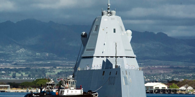 FILE - The guided missile destroyer USS Zumwalt is assisted by a tugboat at Joint Base Pearl Harbor-Hickam, in this Tuesday, April 2, 2019, file photo, in Honolulu. (Craig T. Kojima/Honolulu Star-Advertiser via AP, File)