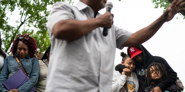 Pastor Brian Herron prays for the families of Trinity Ottoson-Smith and Ladavionne Garrett Jr. during a prayer vigil at North Memorial hospital after three children were shot in the last week in Minneapolis, Tuesday, May 18, 2021. (Associated Press)