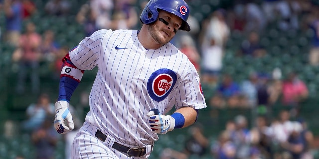 Cubs' Ian Happ rounds the bases after hitting his second home run against the Washington Nationals, May 20, 2021, in Chicago.