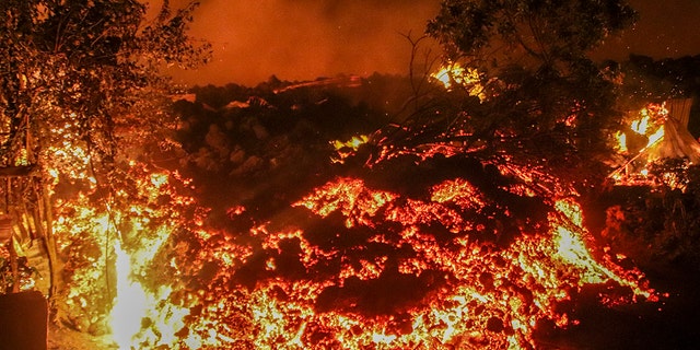 Lava from the eruption of Mount Nyiragongo is seen in Buhene, on the outskirts of Goma, Congo in the early hours of Sunday, May 23, 2021. Congo's Mount Nyiragongo erupted for the first time in nearly two decades Saturday, turning the night sky a fiery red and sending lava onto a major highway as panicked residents tried to flee Goma, a city of nearly 2 million. (AP Photo/Justin Kabumba)