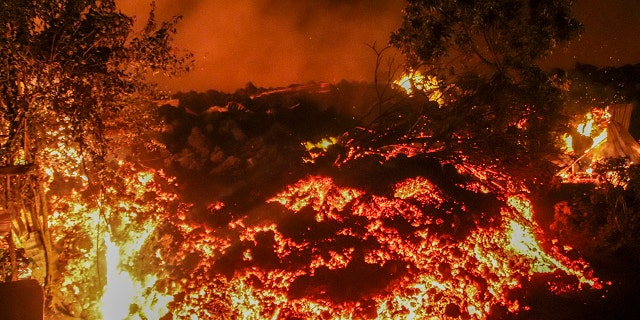 Lava from the eruption of Mount Nyiragongo is seen in Buhene, on the outskirts of Goma, Congo in the early hours of Sunday, May 23, 2021. Congo's Mount Nyiragongo erupted for the first time in nearly two decades Saturday, turning the night sky a fiery red and sending lava onto a major highway as panicked residents tried to flee Goma, a city of nearly 2 million. (AP Photo/Justin Kabumba)