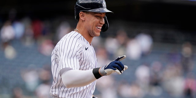 New York Yankees designated hitter Aaron Judge reacts after drawing a bases-loaded walk for the winning run against the Chicago White Sox May 23, 2021, at Yankee Stadium in New York.