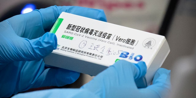 A medical worker holds a package for a Sinopharm vaccine at a vaccination facility in Beijing on Jan. 15, 2021. Two vaccines made by China’s Sinopharm appear to be safe and effective against COVID-19, according to a study published in a medical journal. Scientists have been waiting for more details about the two vaccines, even though they already are being used in many countries and one recently won the backing of the World Health Organization. (AP Photo/Mark Schiefelbein)