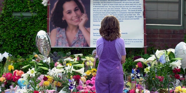 In this April 21, 2003 file photo of Sarah Kellison stands in front of a memorial in honor of Laci Peterson outside the home that Laci shared with her husband Scott Peterson in Modesto, Calif. (AP Photo / Marcio Jose Sanchez, File)