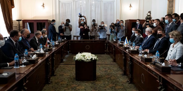 Egyptian Foreign Minister Sameh Shoukry, third from left, meets with Israeli Foreign Minister Gabi Ashkenazi, second from wldright, at the Tahrir Palace in Cairo, Egypt, Sunday, May 30, 2021. (AP Photo/Nariman El-Mofty)